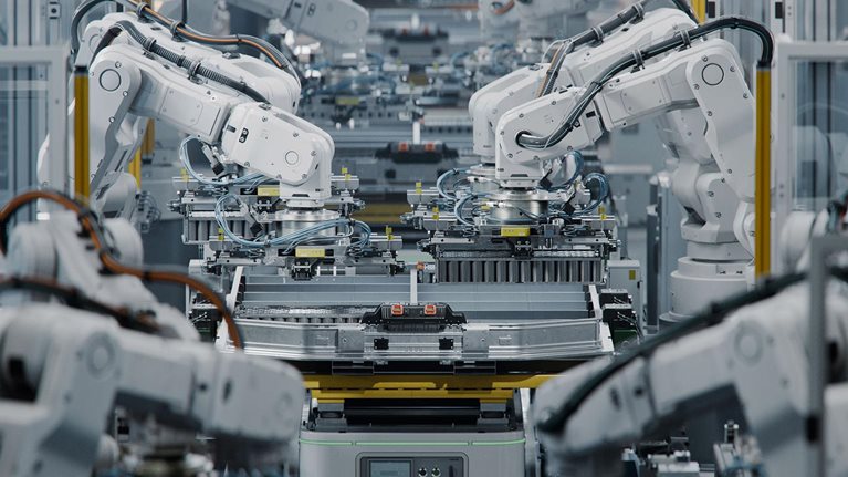 Lithium-Ion EV Battery Pack Production at Large Automated Assembly Line at Bright Factory Equipped With Industrial Robot Arms. Electric Car Manufacturing.