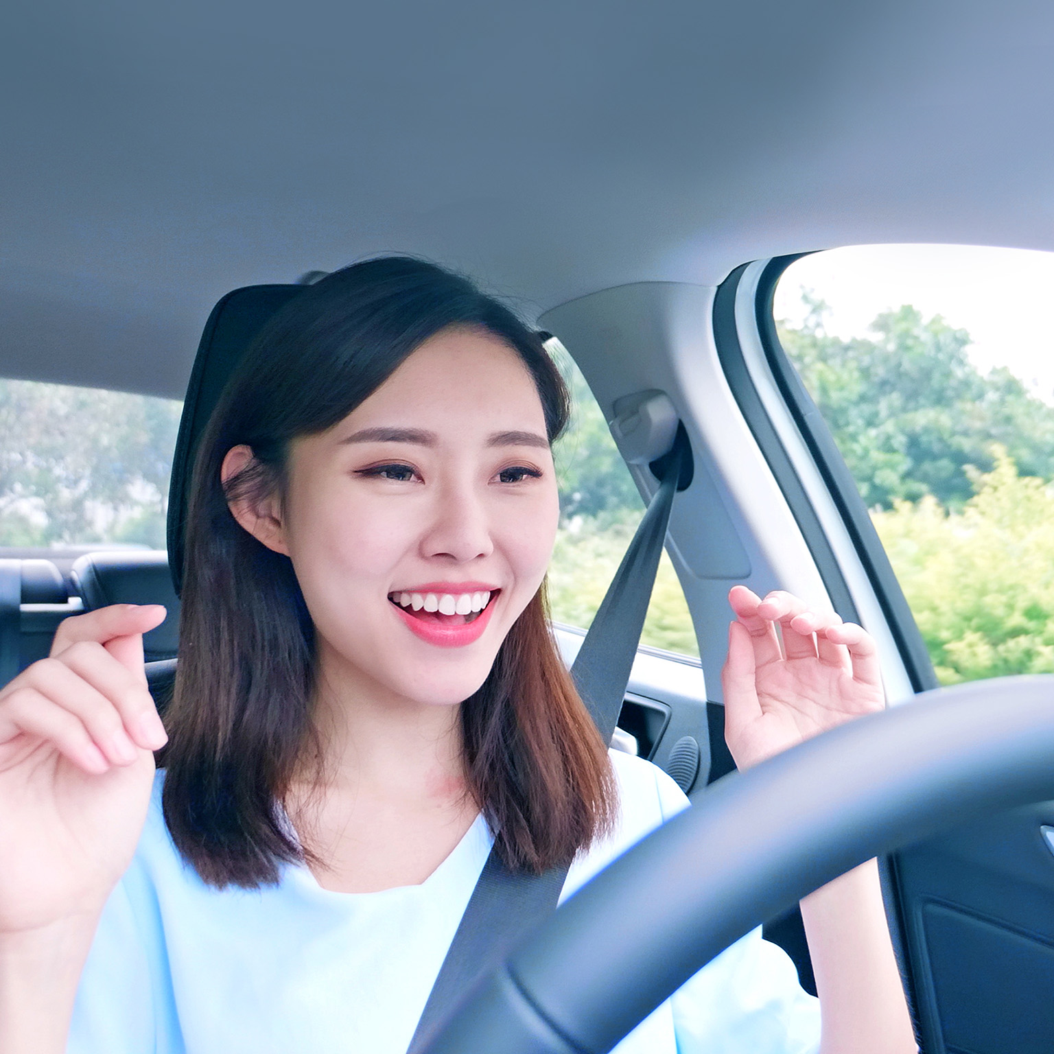 A woman behind the steering wheel of an autonomous self driving car