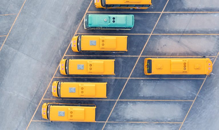 Aerial view of electric bus at factory parking lot.