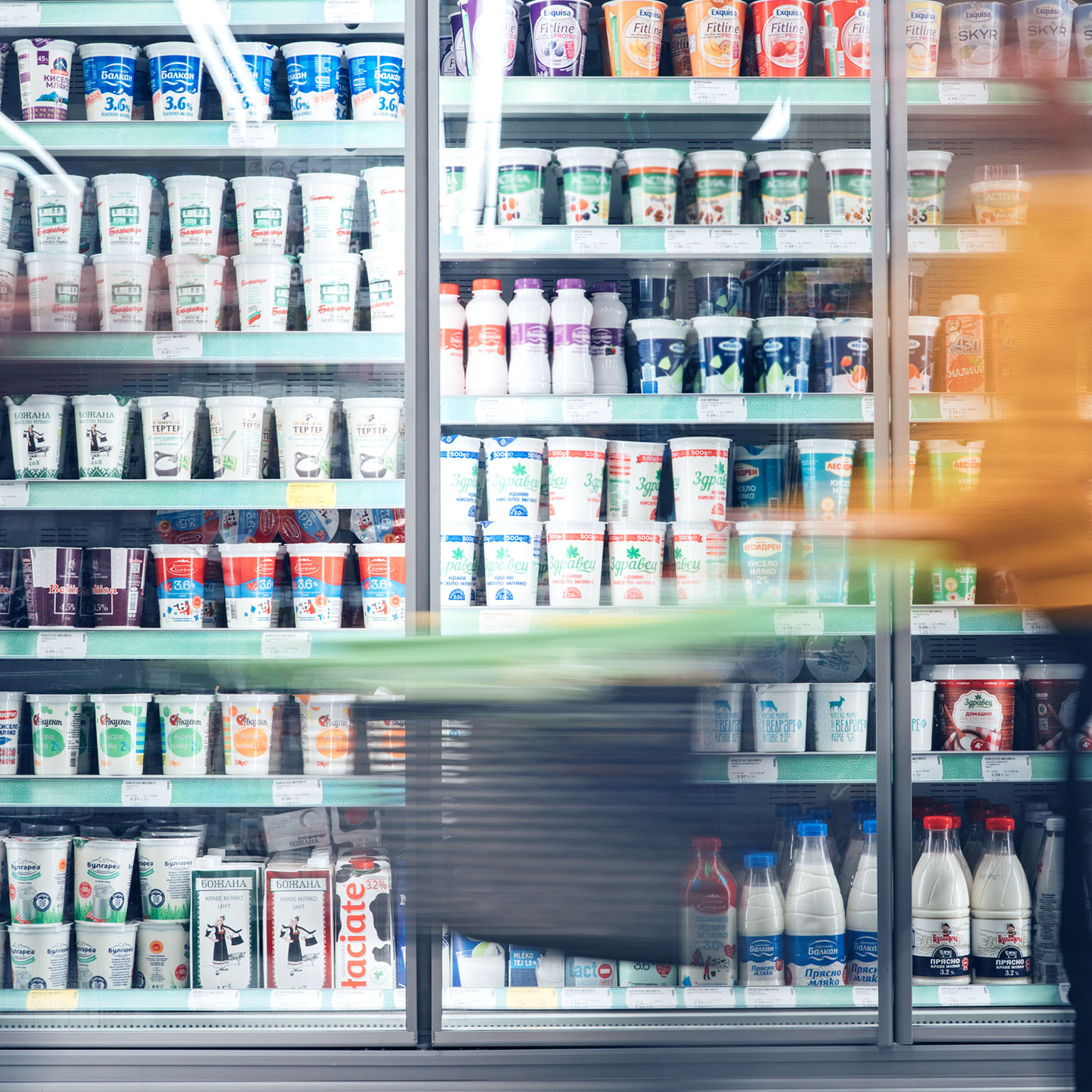 Blurred motion of energetic people on the move while shopping in a grocery store.