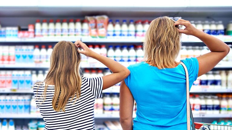 Family chooses dairy products in shop