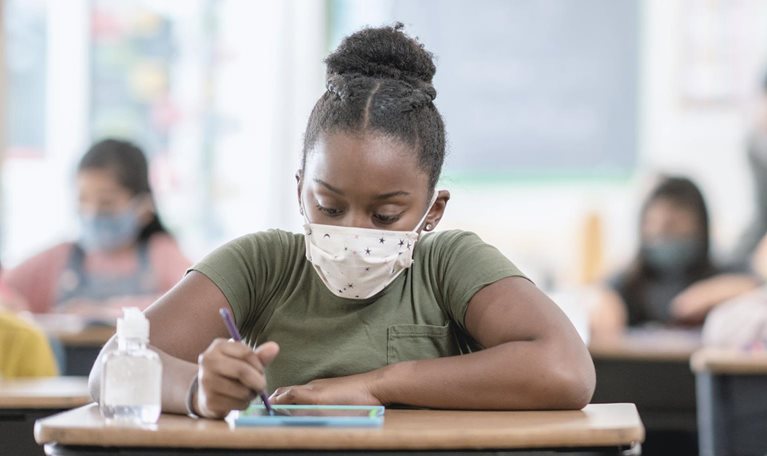 Student wearing mask at desk