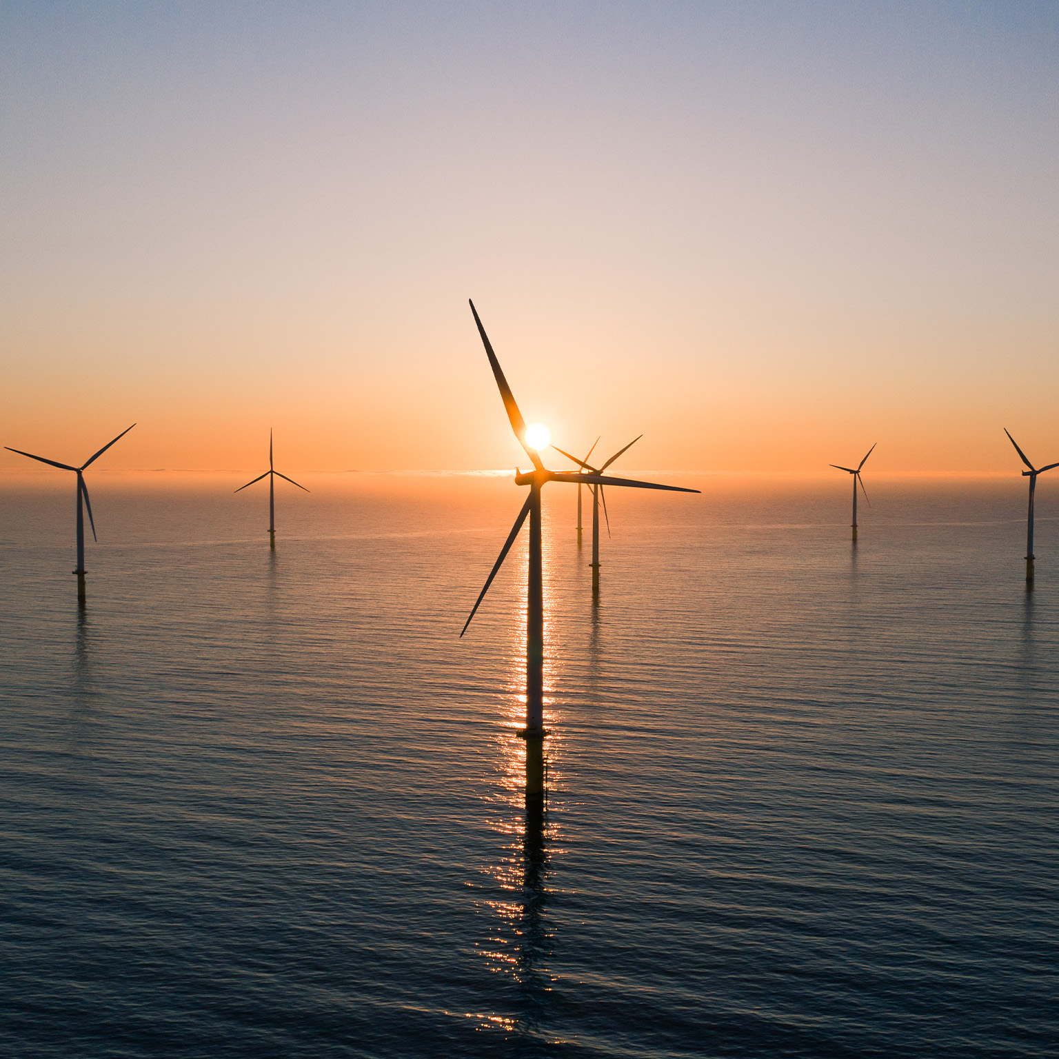 Offshore wind turbines at sunrise seen from an aerial point of view, Redcar, England, United Kingdom - stock photo