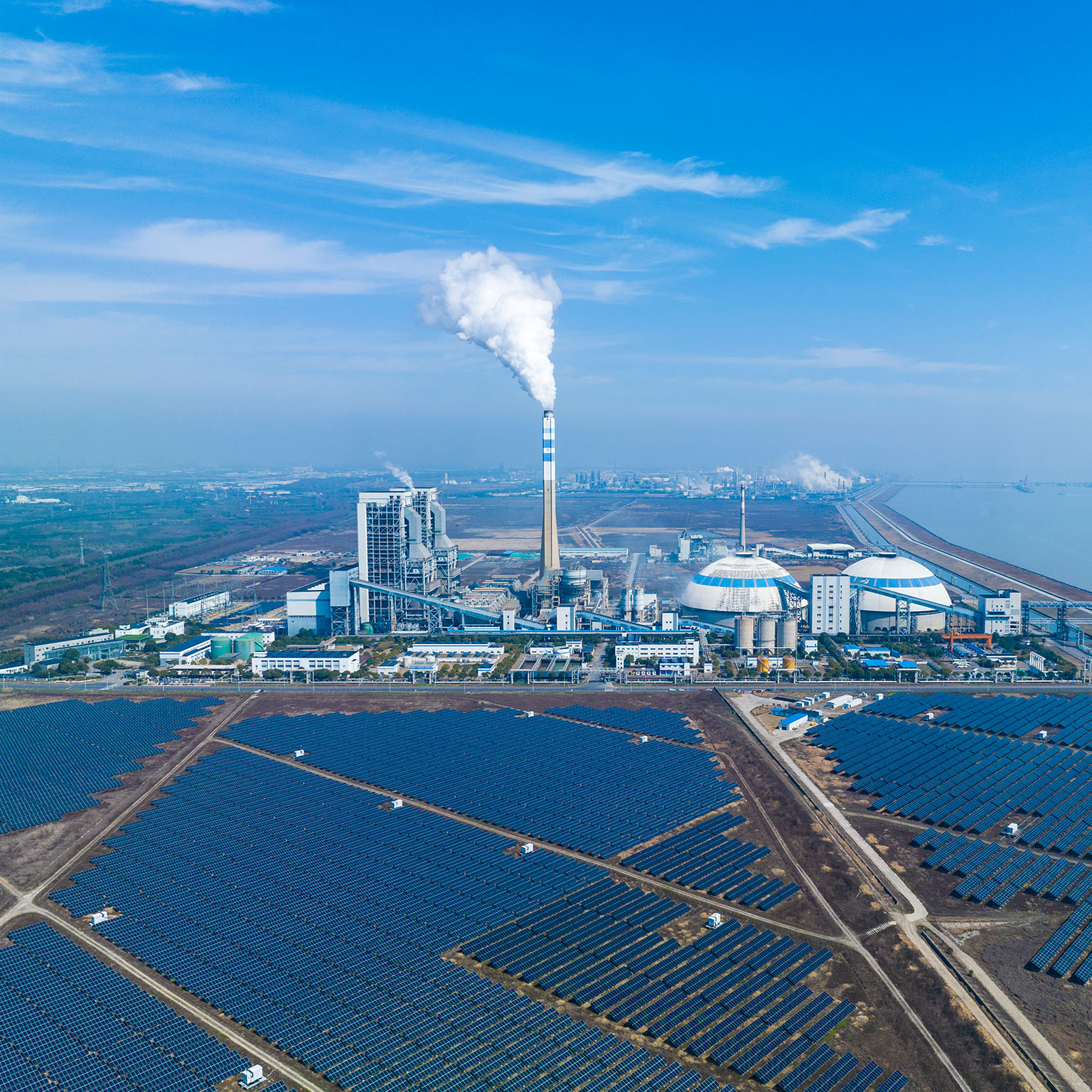 Aerial view of solar power station and coal fired power station: Clean energy and coal energy - stock photo