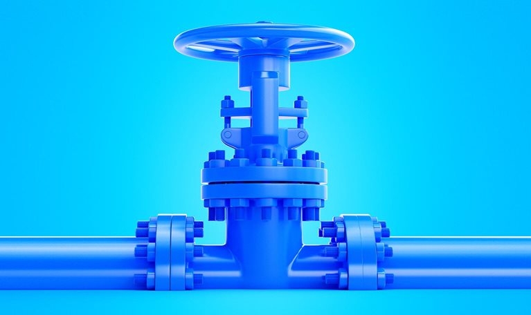 An image of a blue industrial valve that is centrally positioned on a blue pipeline against a matching blue background.