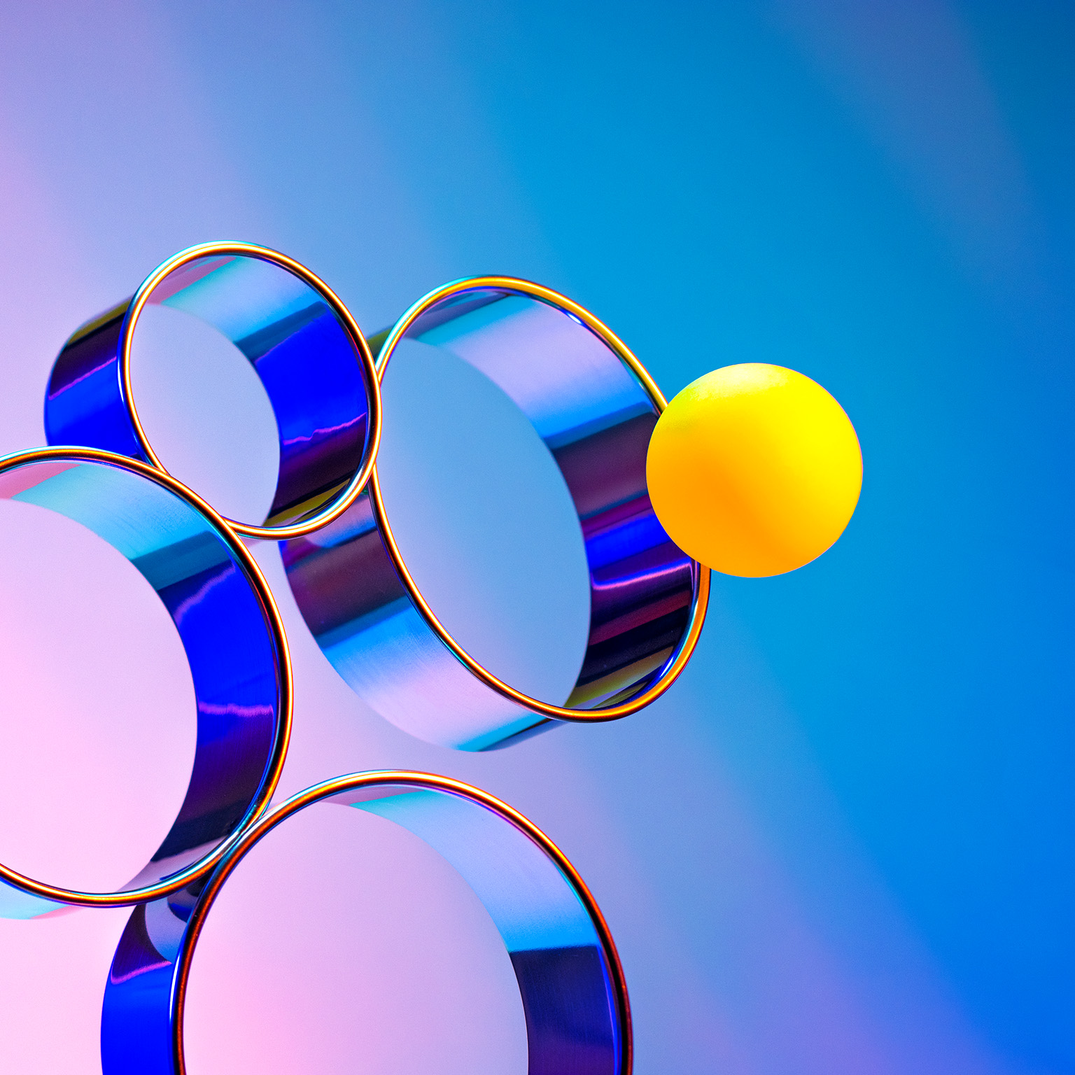 Abstract array of rings and a ball going through a specific ring.