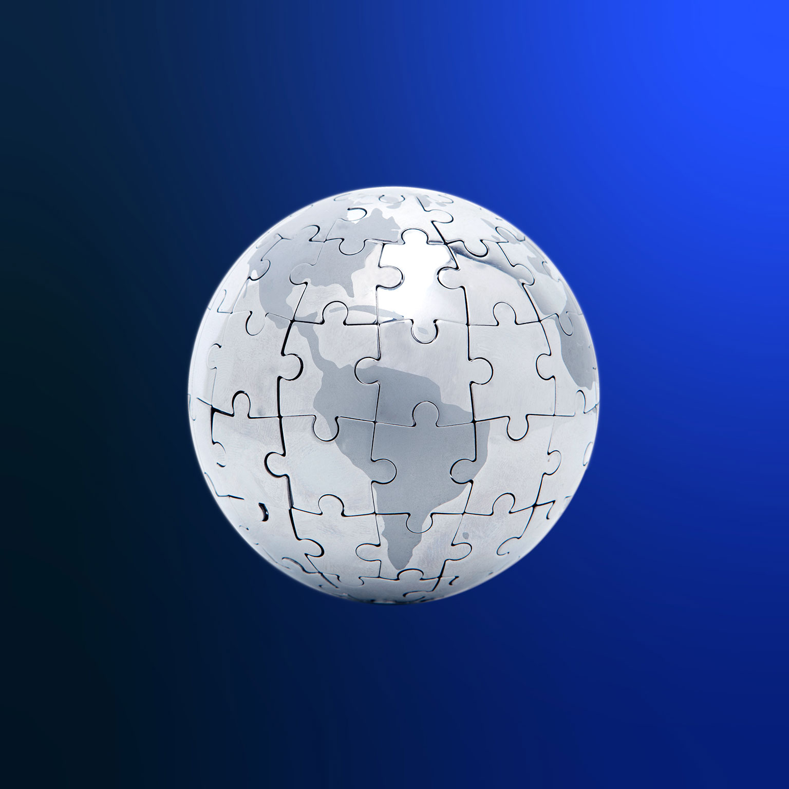 Silver 3D globe puzzle centering on South America