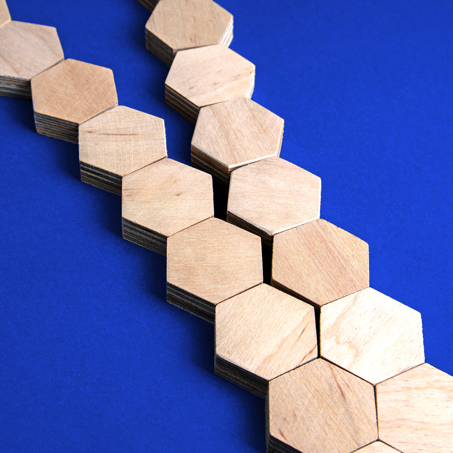 Two separate chains of wooden blocks converge to form a single chain.