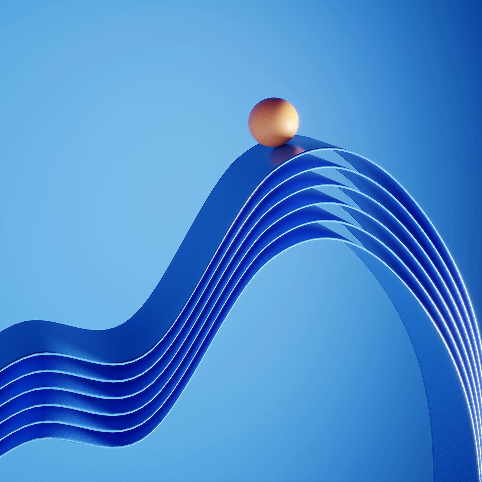 Orange colored ball standing on top of the ribbons