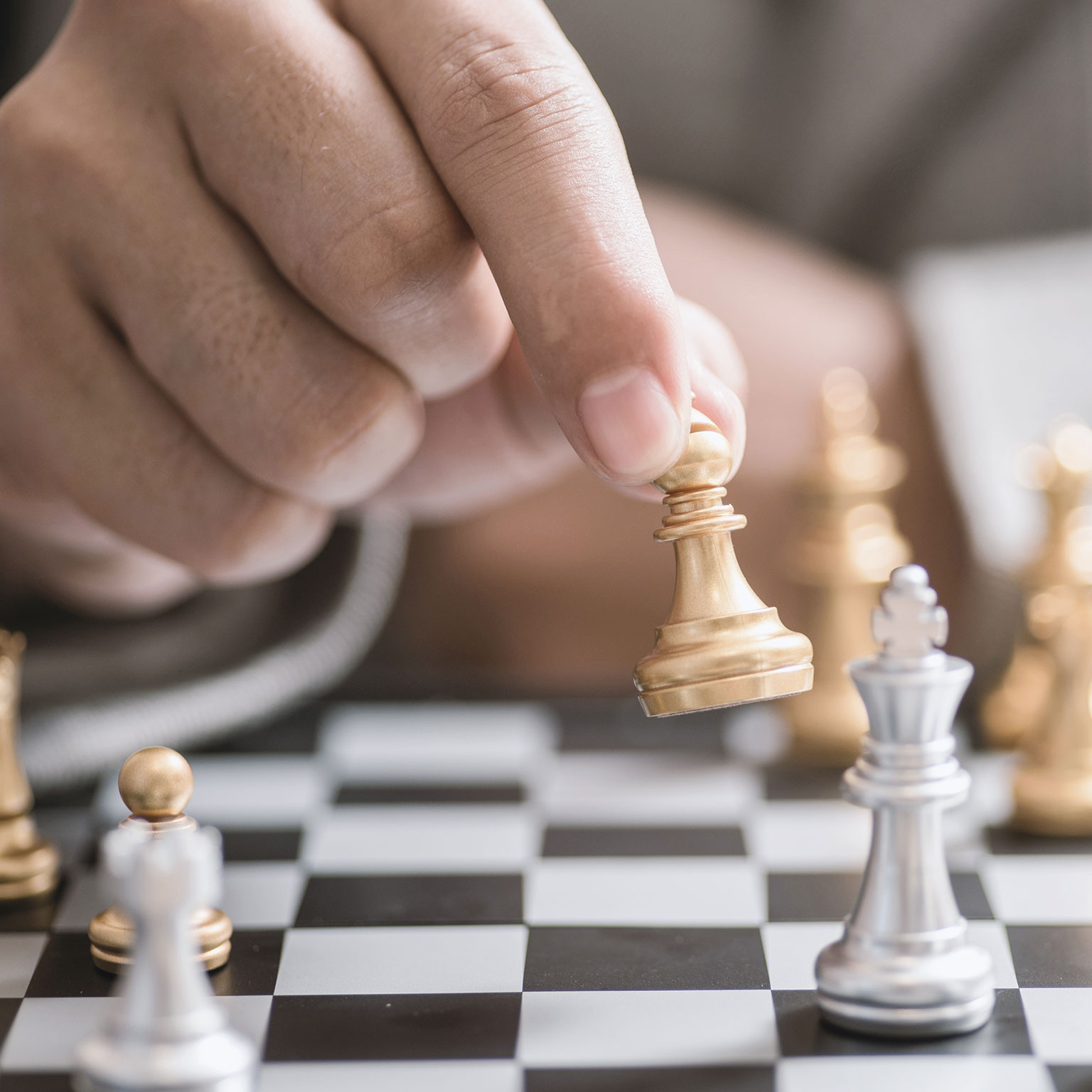Close up of hand moving chess piece
