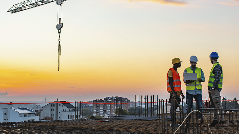 Construction workers atop building