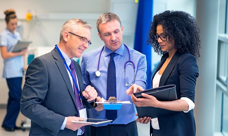 Three medical professional having a discussion in a medical room