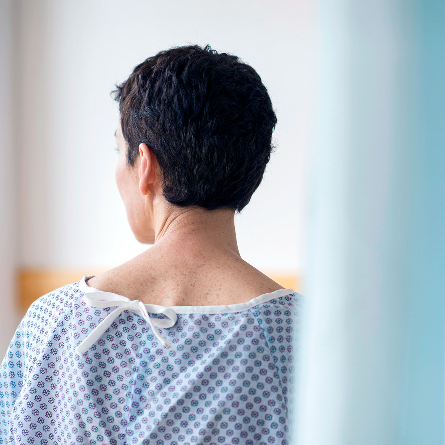 Rear view of senior woman wearing hospital gown
