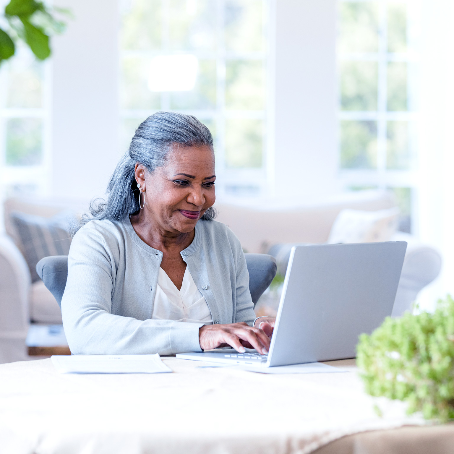 An elderly lady accessing healthcare online with ease