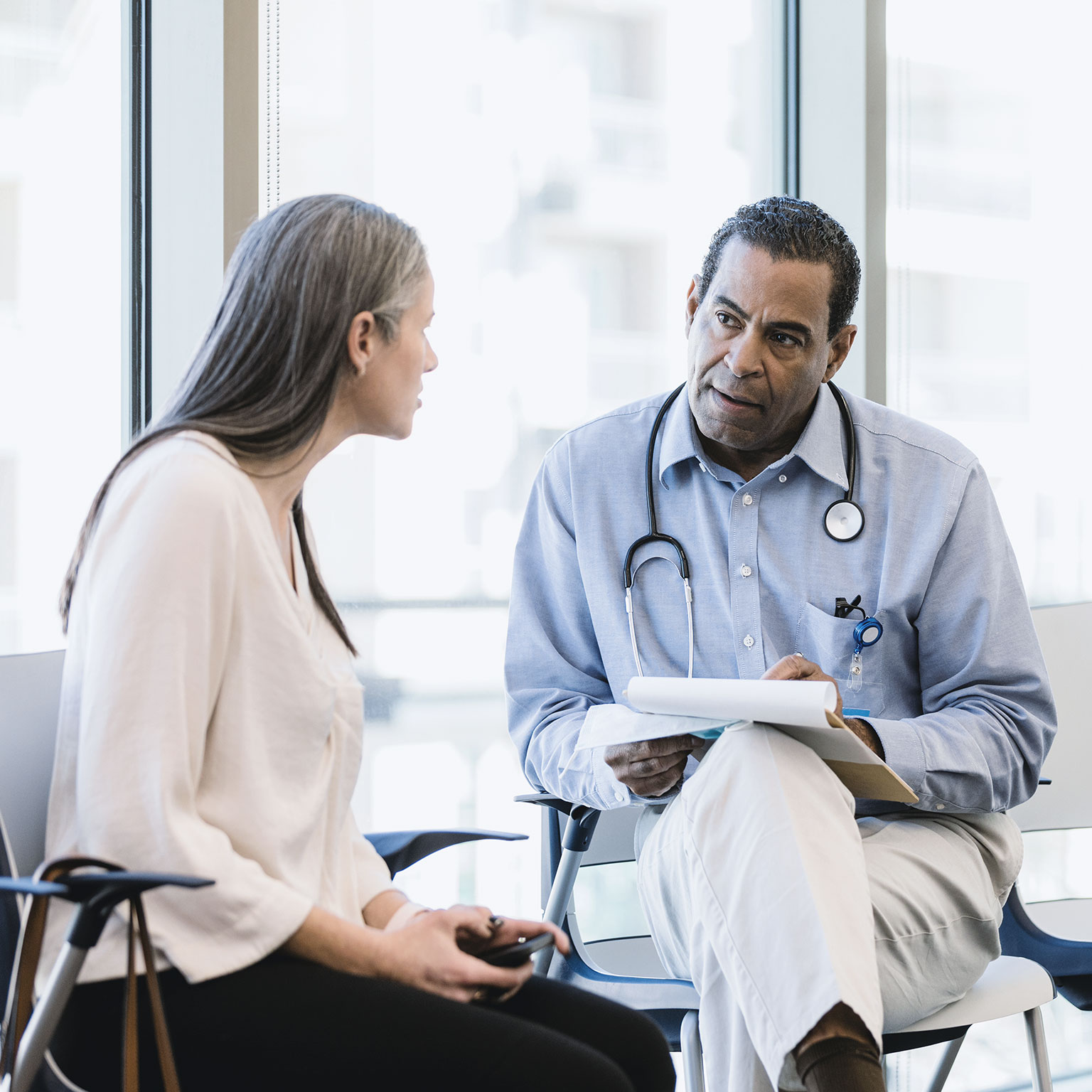 Physician listens to the new staff member - stock photo