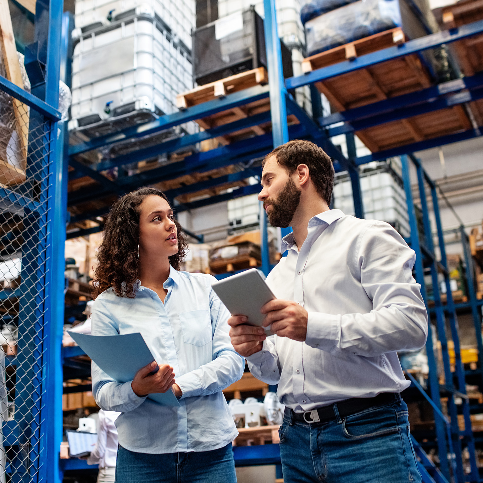 Warehouse employees checking stock levels in company warehouse. - stock photo