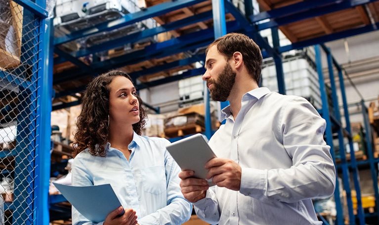 Warehouse employees checking stock levels in company warehouse. - stock photo
