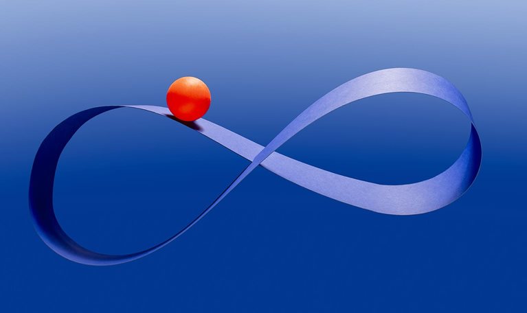 Bright red ball riding on blue mobius infinity strip in mid-air against blue background
