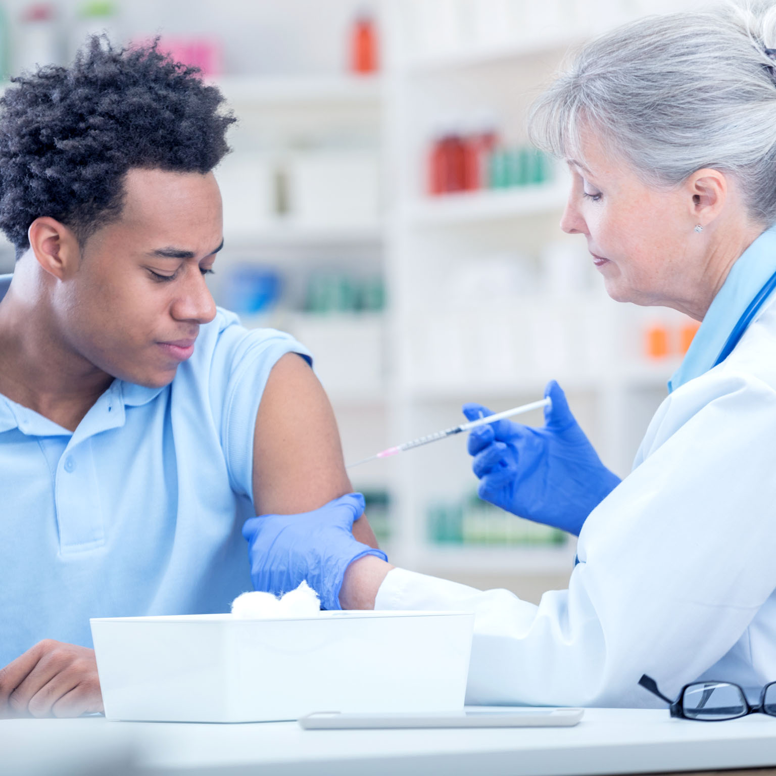 Photo of a man being vaccinated at a pharmacy.