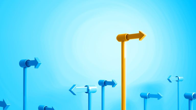 A field of blue directional arrows, all pointing in various directions, with one bright yellow arrow that stands above the rest.