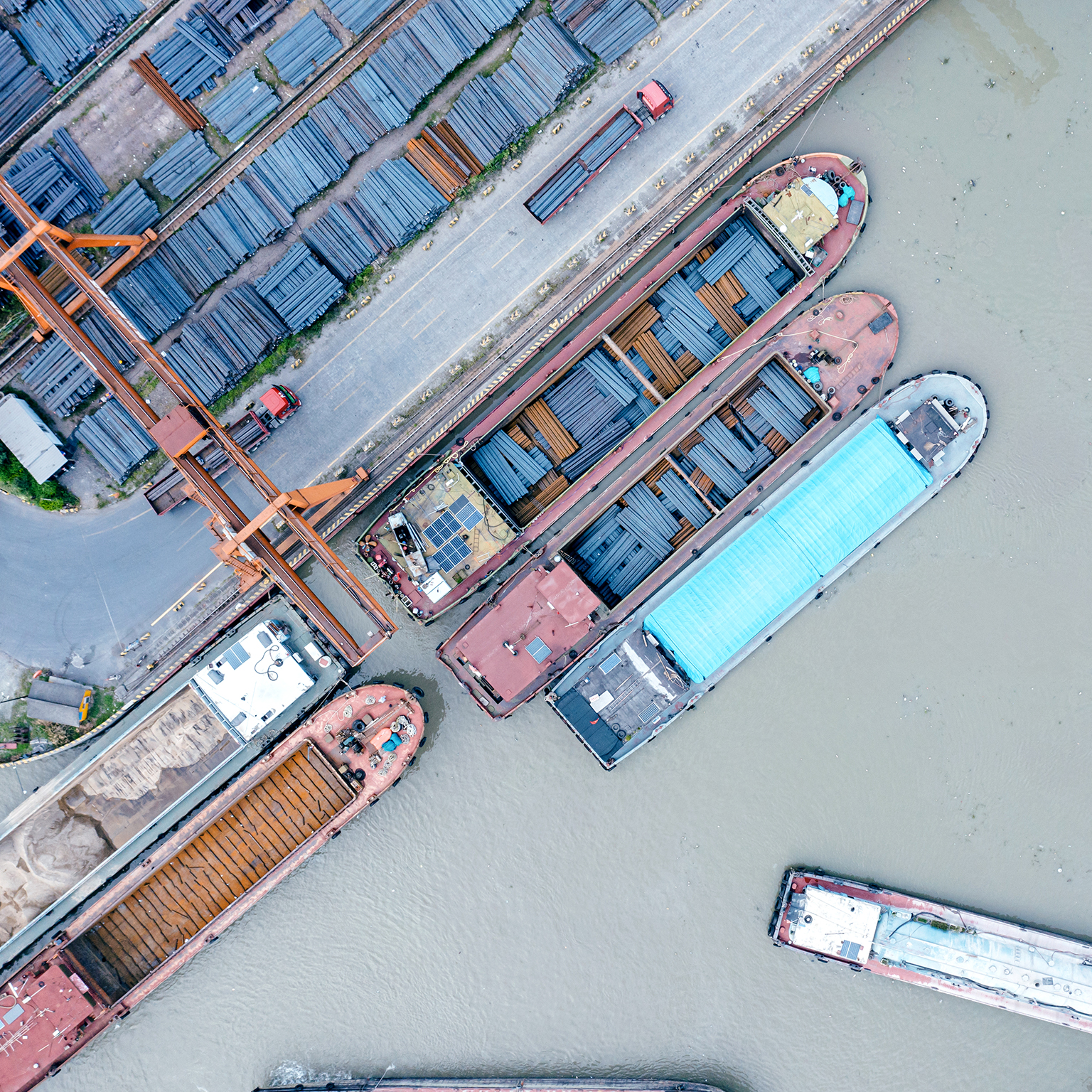 Aerial view of cargo ships docked at a steel terminal
