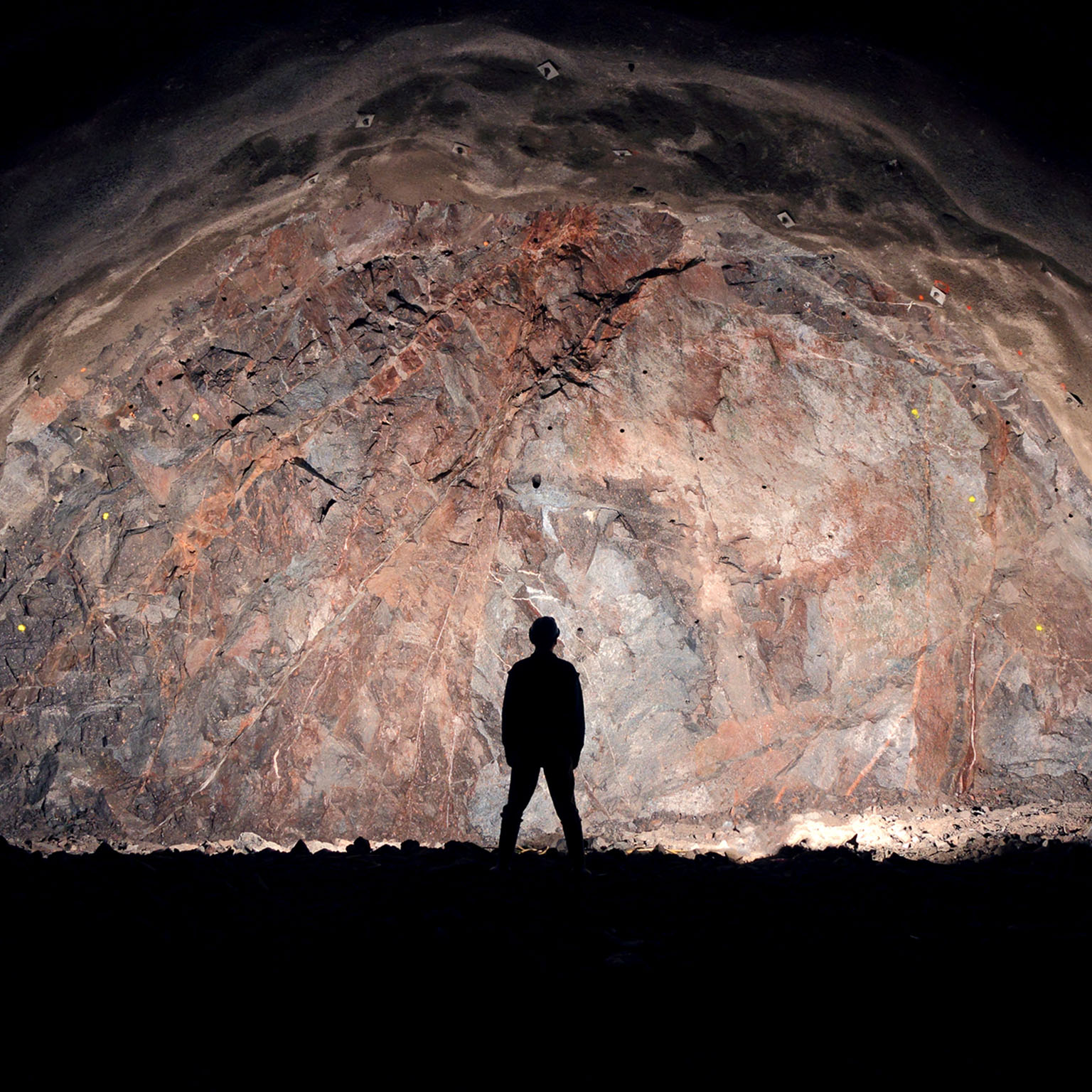 Mine, tunnel front, silhouette of a standing worker
