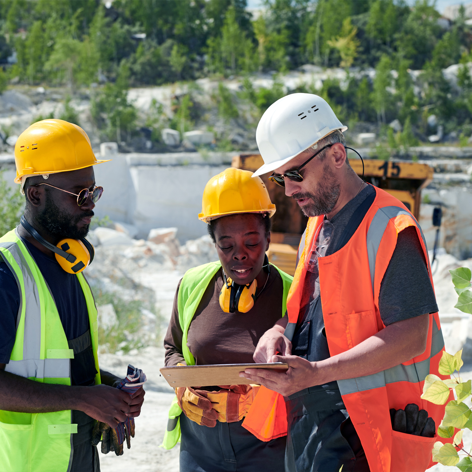 Mature man in workwear pointing at tablet screen during presentation