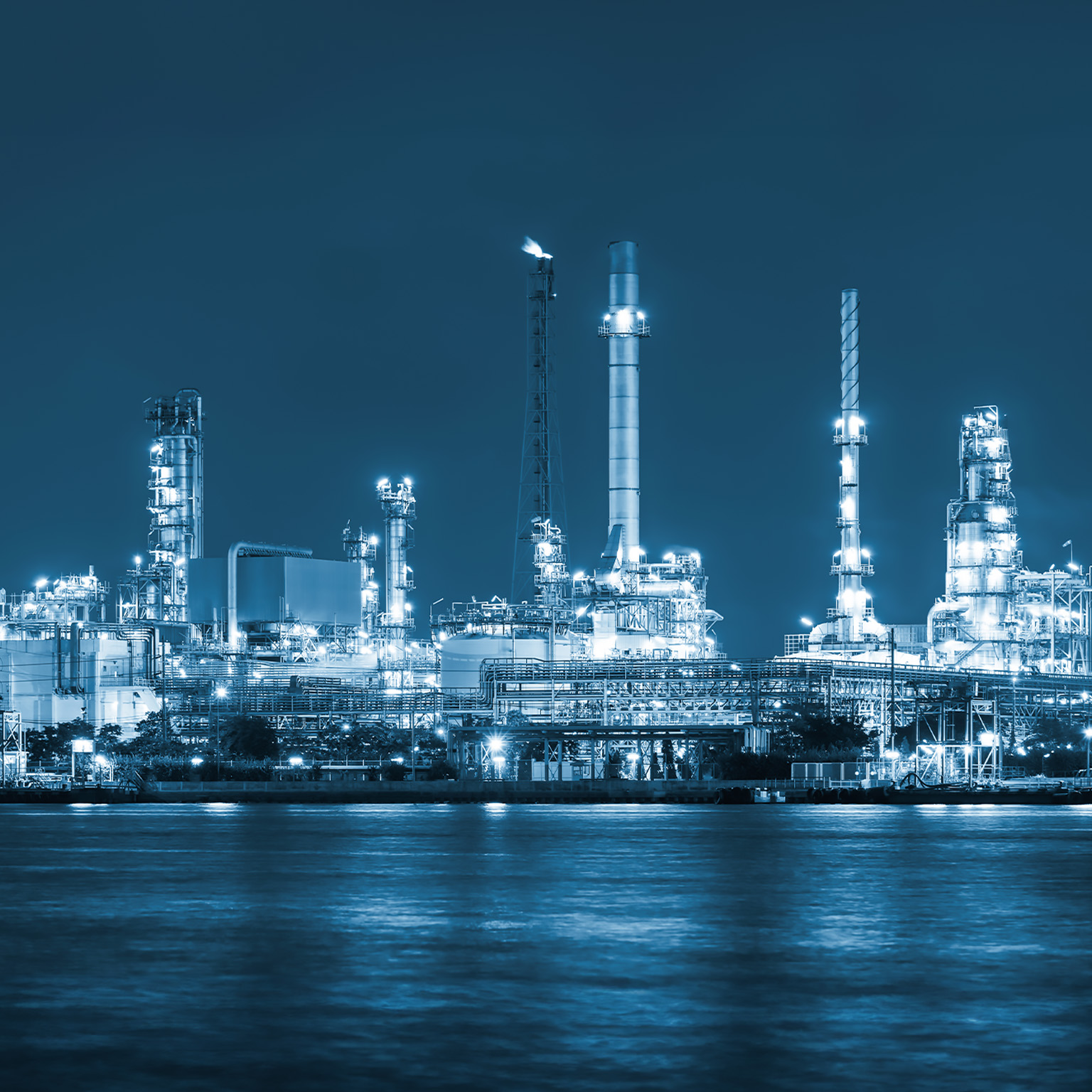 Oil refinery at night - stock photo