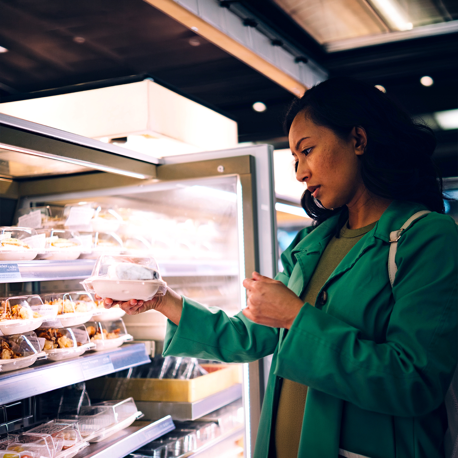 Woman buying packed food from cafe