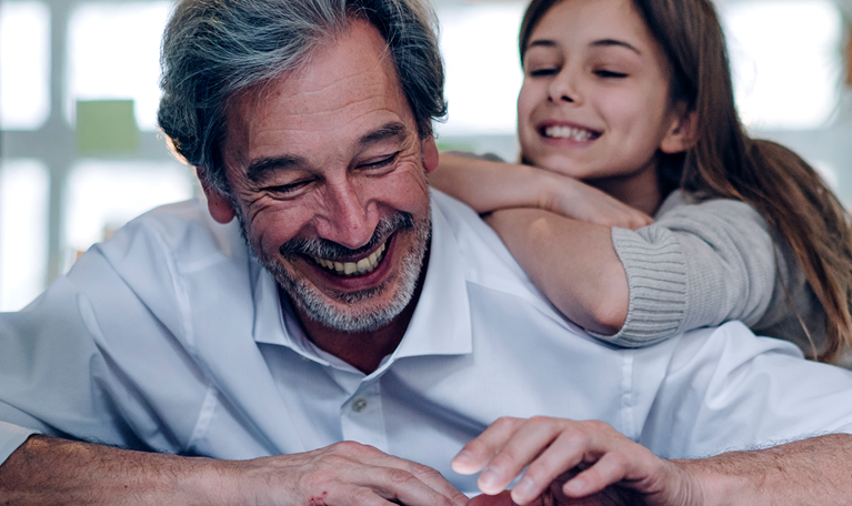 Happy senior businessman and girl looking at tablet in office.