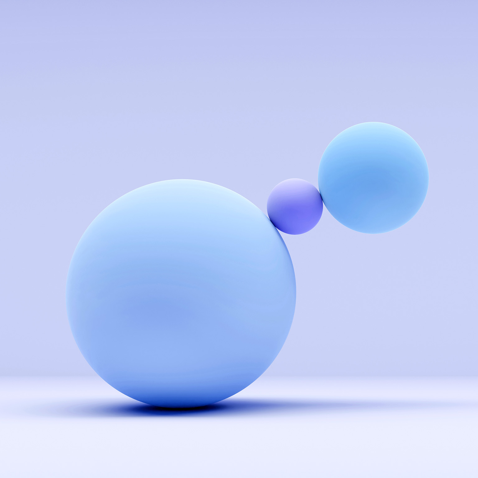 A 3D image shows three spheres of different sizes, with the largest sphere on the left and two smaller spheres to its right, one of which is significantly smaller than the others.