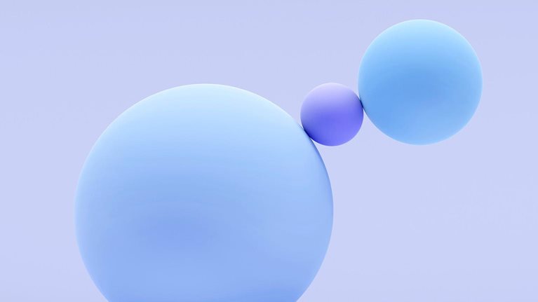 A 3D image shows three spheres of different sizes, with the largest sphere on the left and two smaller spheres to its right, one of which is significantly smaller than the others.