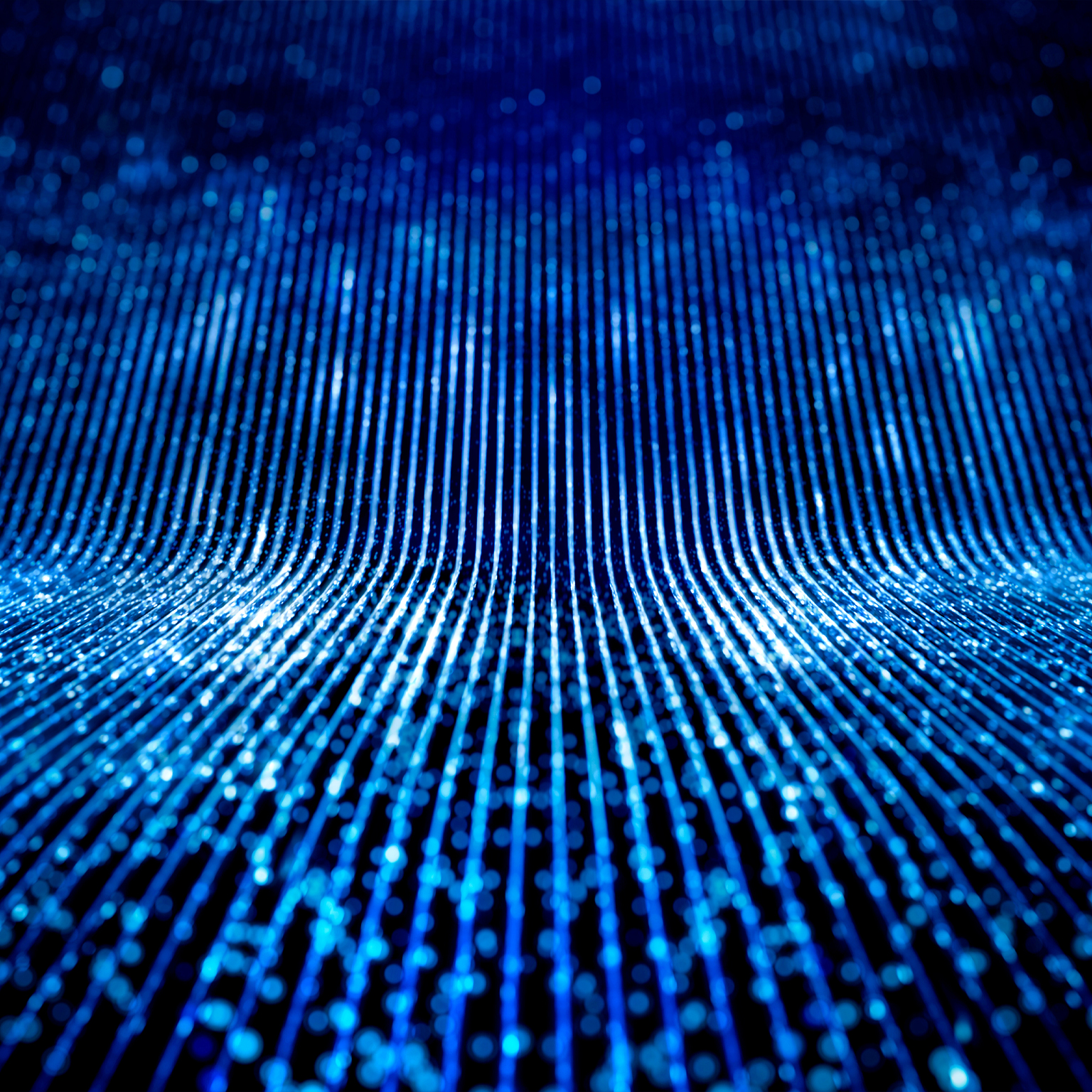 Data network flowing as blue glowing lines running parallel behind a blurred dark background