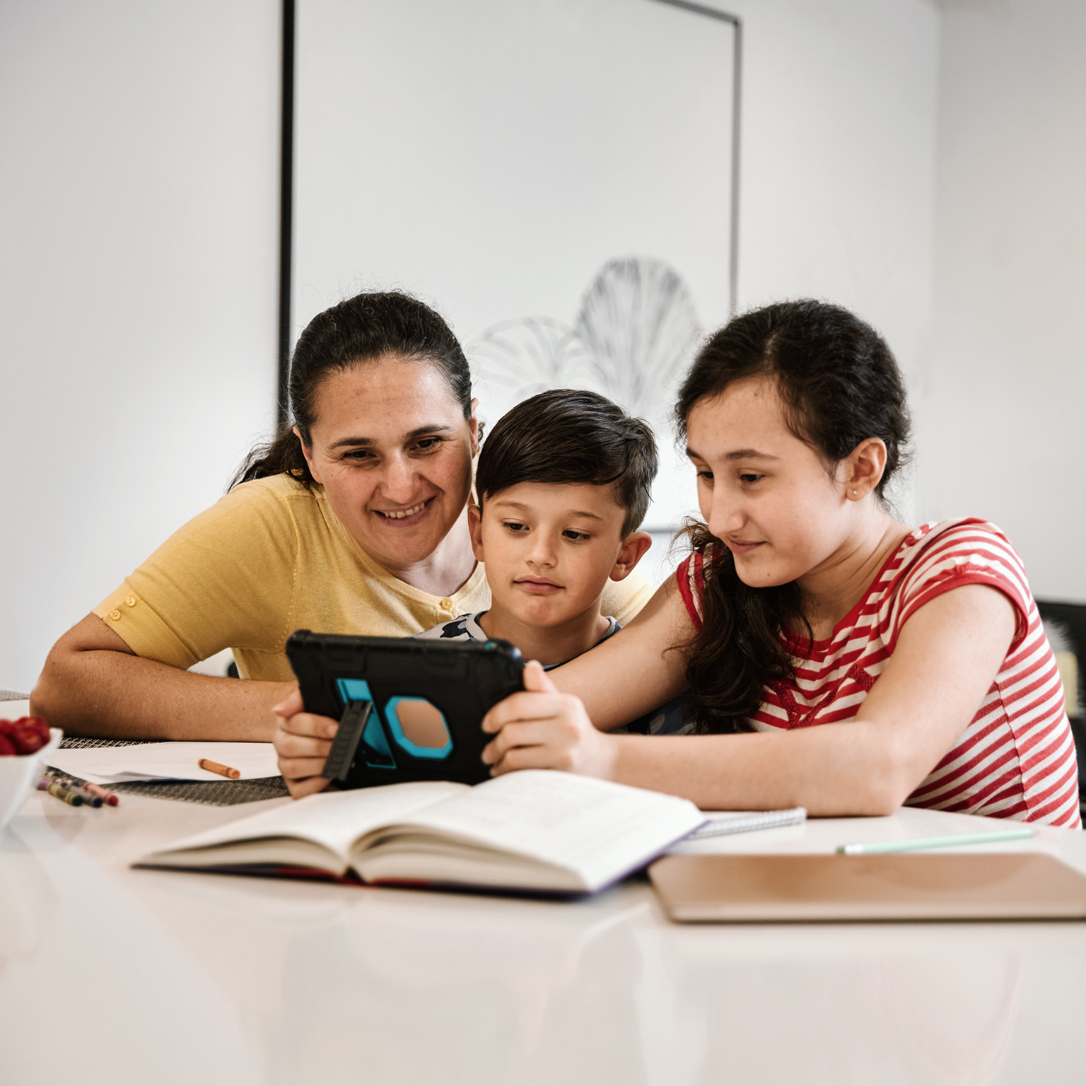 Woman and children looking at tablet