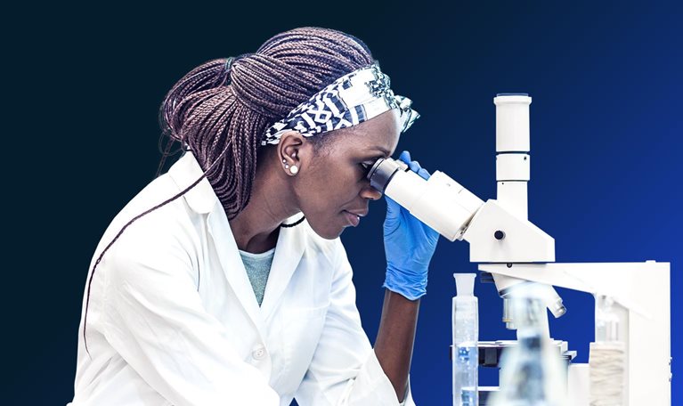 Female scientist working in the laboratory, using a microscope