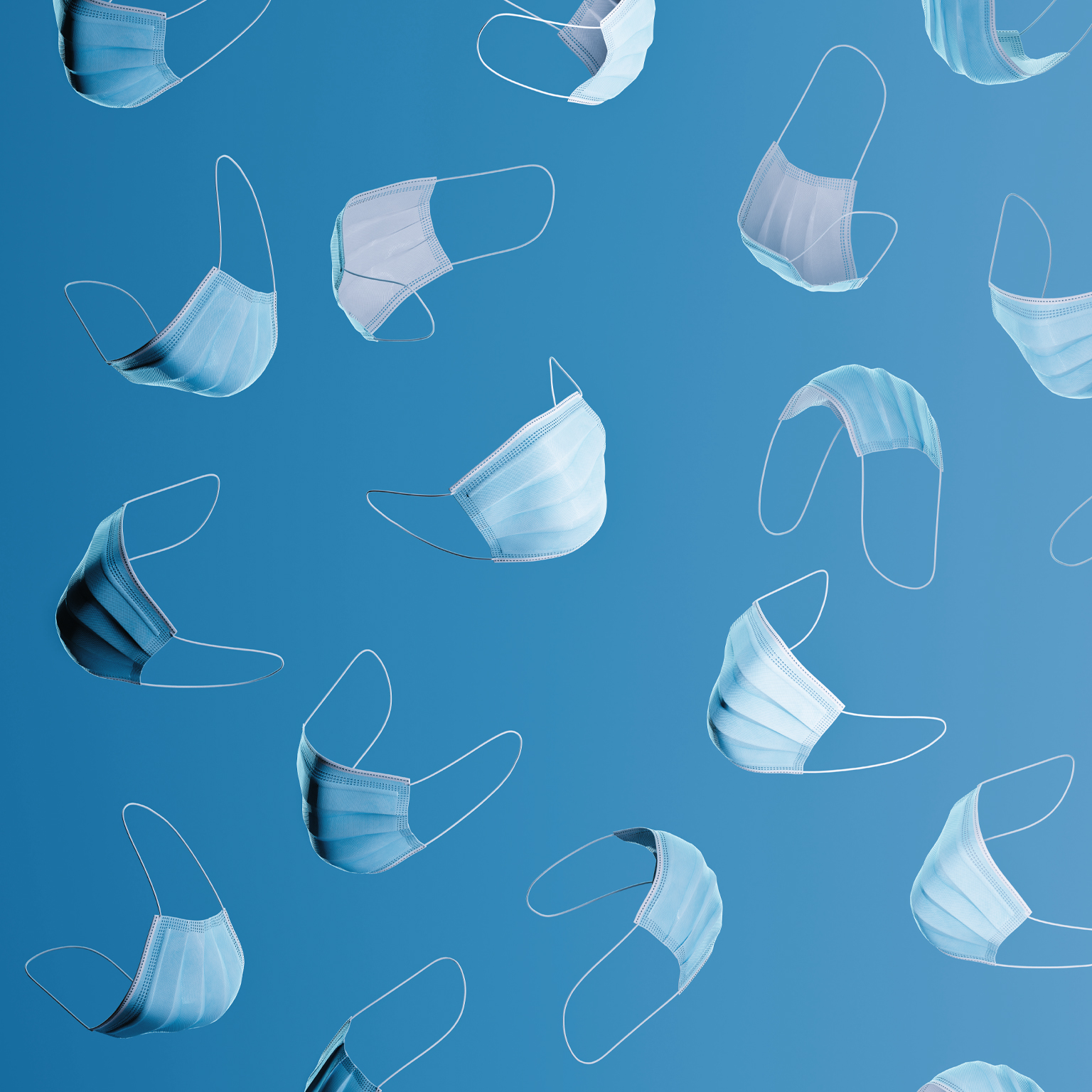 Many blue surgical masks floating on a blue background