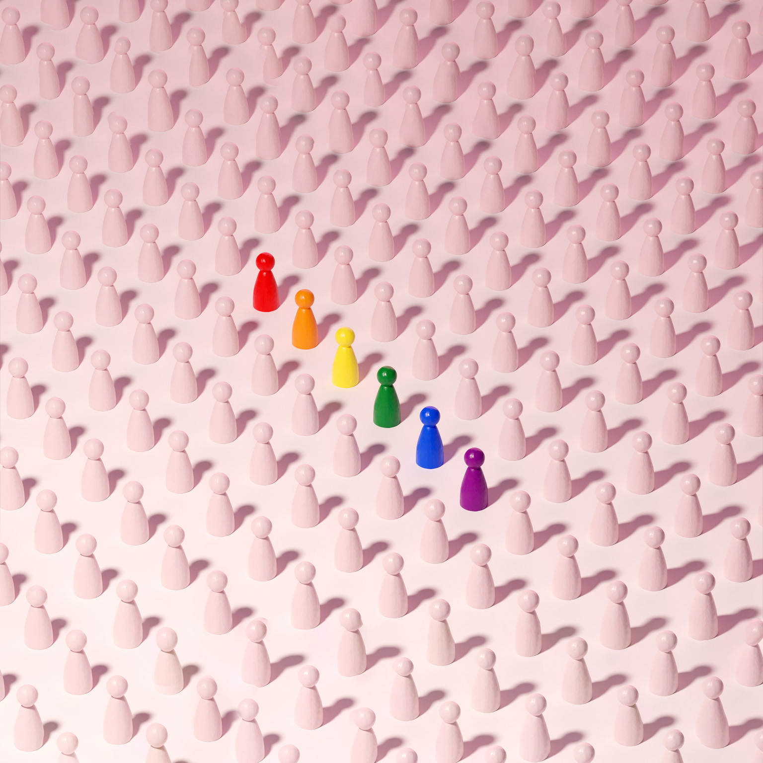 Conceptual image of a grid pattern of neutral figures with one row standing out in rainbow colors.
