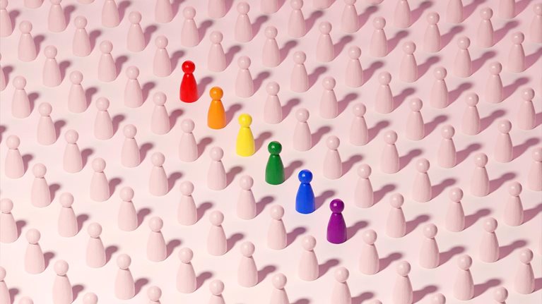Conceptual image of a grid pattern of neutral figures with one row standing out in rainbow colors.