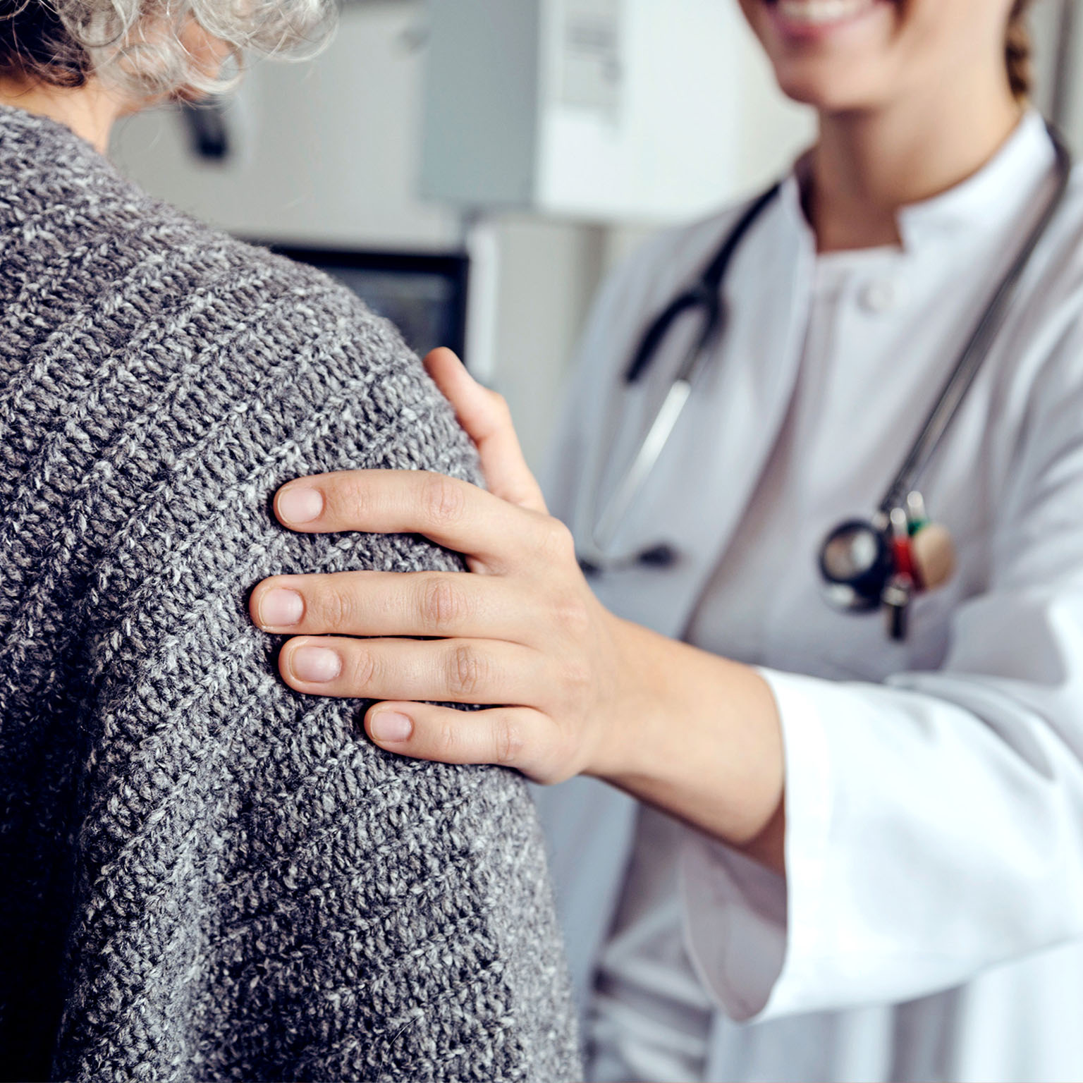 Doctor soothing senior patient