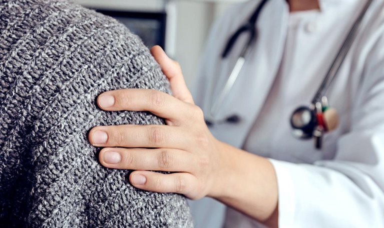 Doctor soothing senior patient