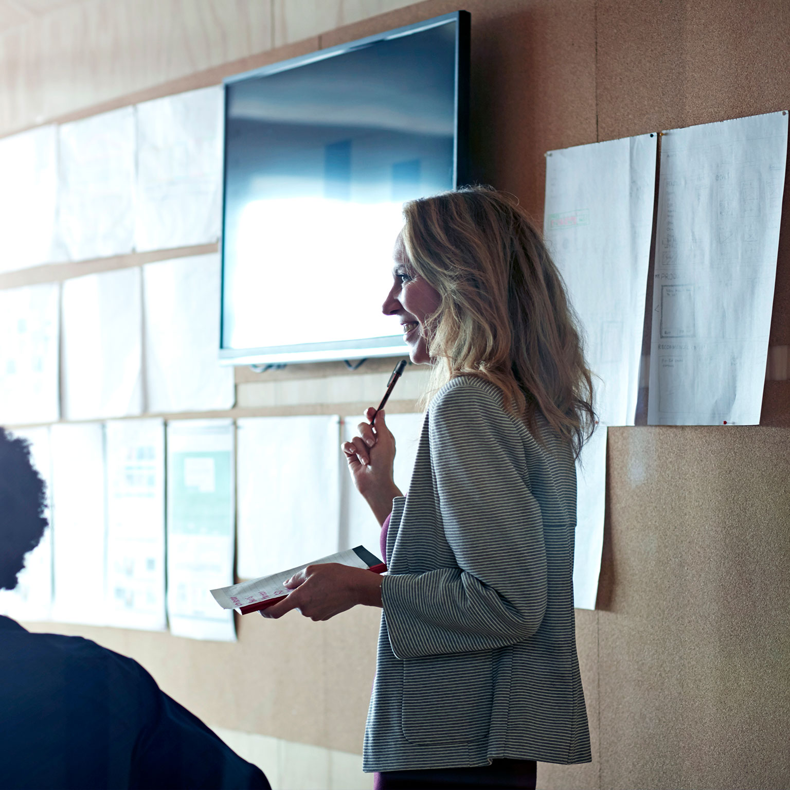 Woman doing presentation, using tablet & screen 