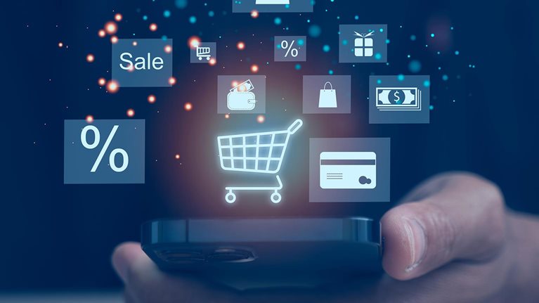 Hand holding a smartphone displaying floating shopping and payment icons, including a cart, discount symbol, and credit card.