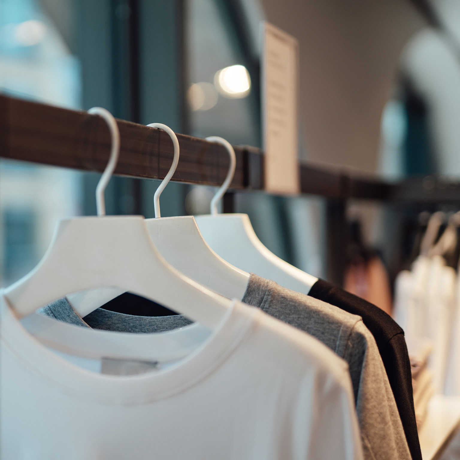 Clothes hanging on rack in fashion store