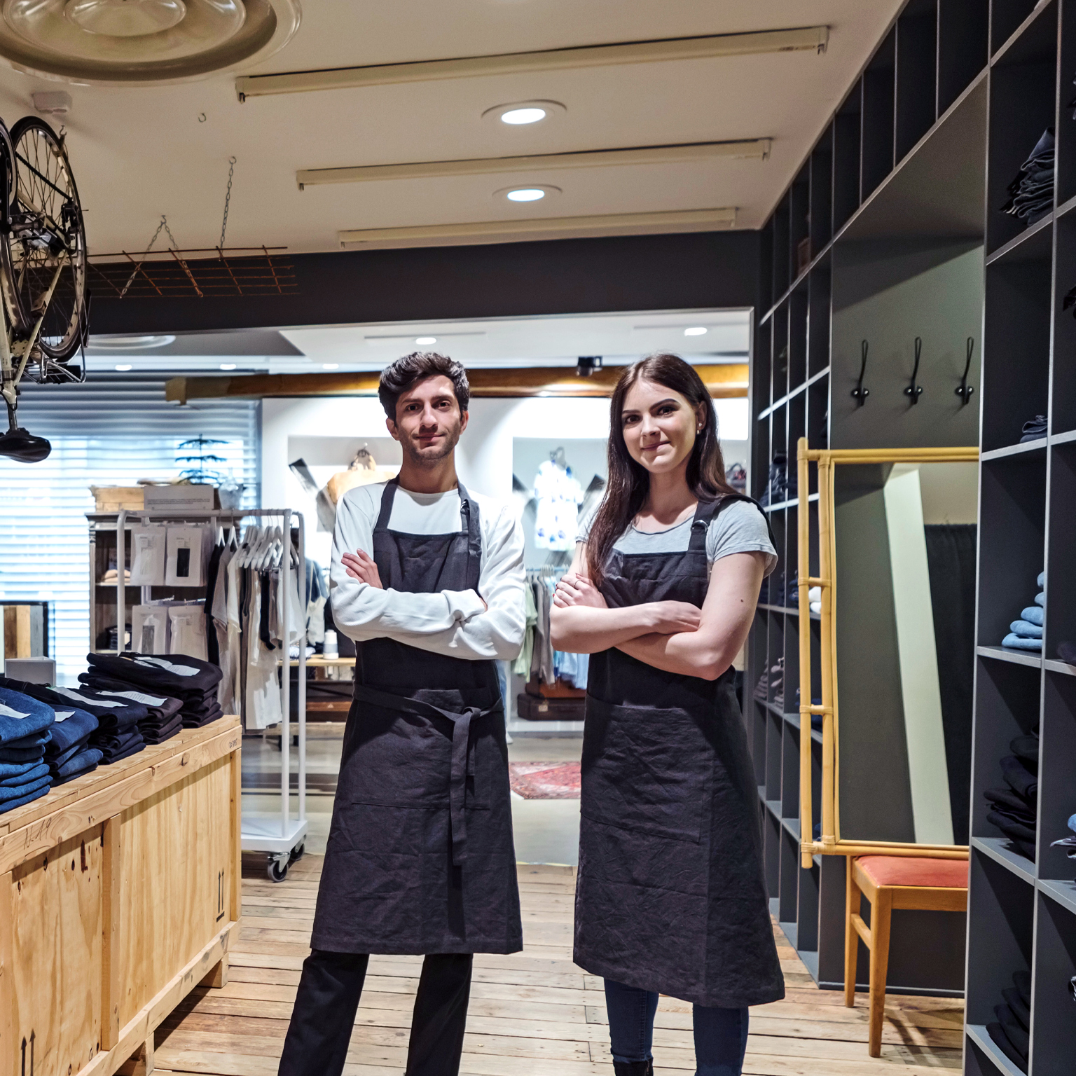 Two workers standing in a retail store environment