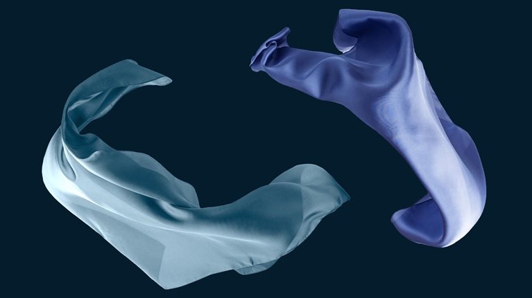 Flowing blue silk scarf isolated on black background