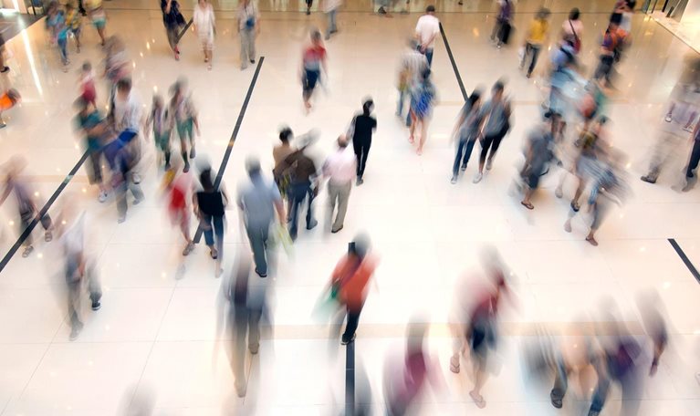 Crowd of people walking through a shopping mall