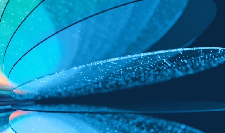 An abstract close-up of layered, translucent curved silicon wafer like forms in shades of blue, teal, and pale orange, with glowing dotted textures along their surfaces. The shapes overlap and reflect across a dark blue background.