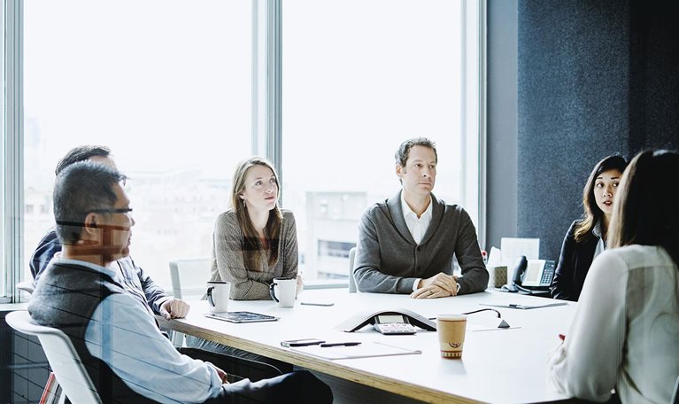 Coworkers in morning meeting in conference room