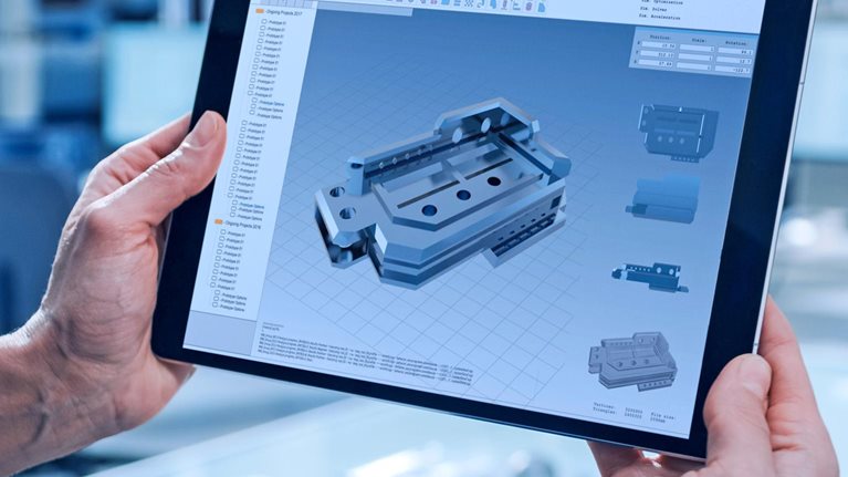 A worker using a tablet computer to operate machinery.