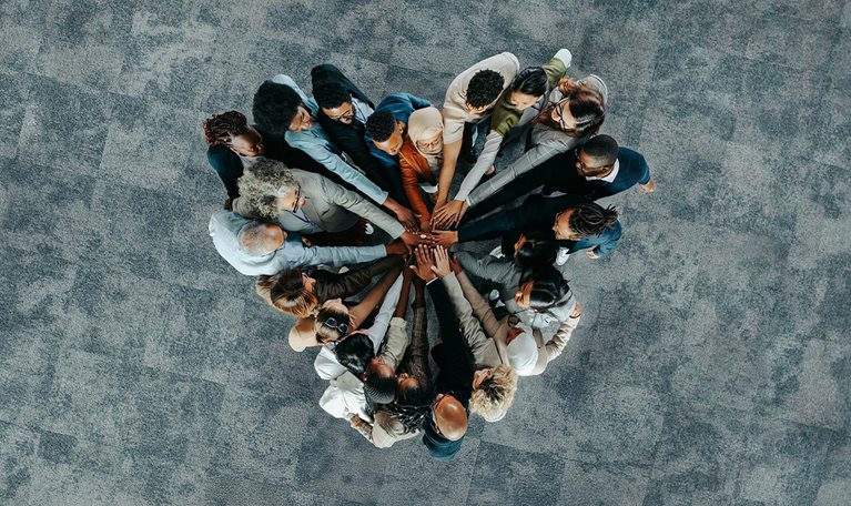 Top view of a a heart shape of people, showing unity and teamwork